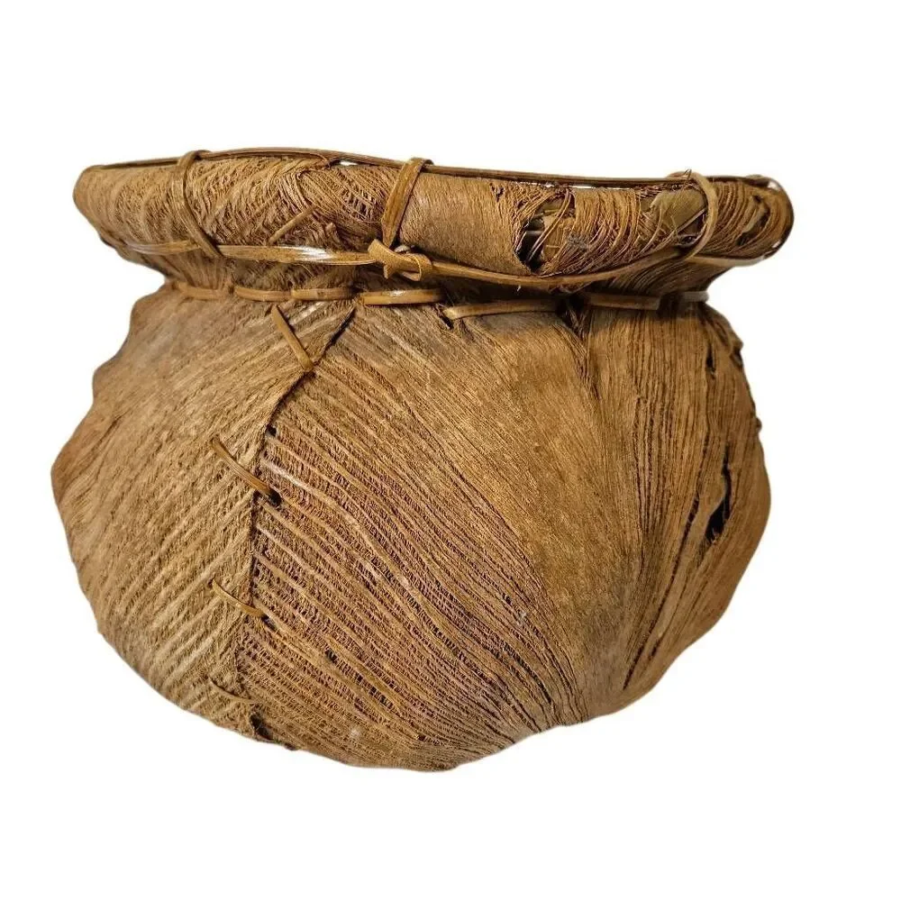 Primitive handmade basket, dried palm leaf woven.